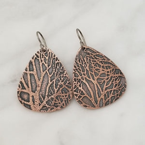 Organic tree patterned copper earrings, triangular shape.
